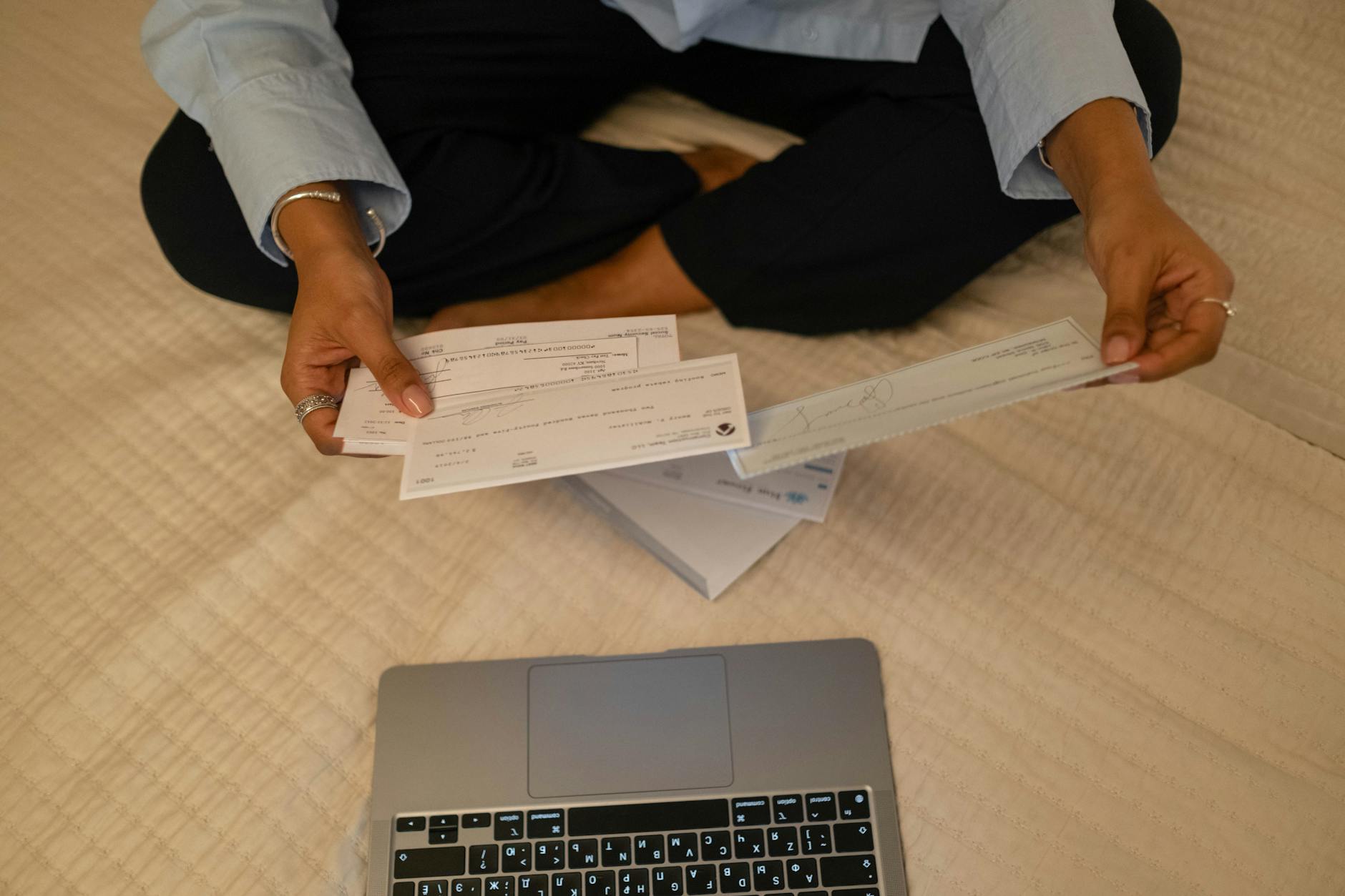 photo of a person s hands holding cheques